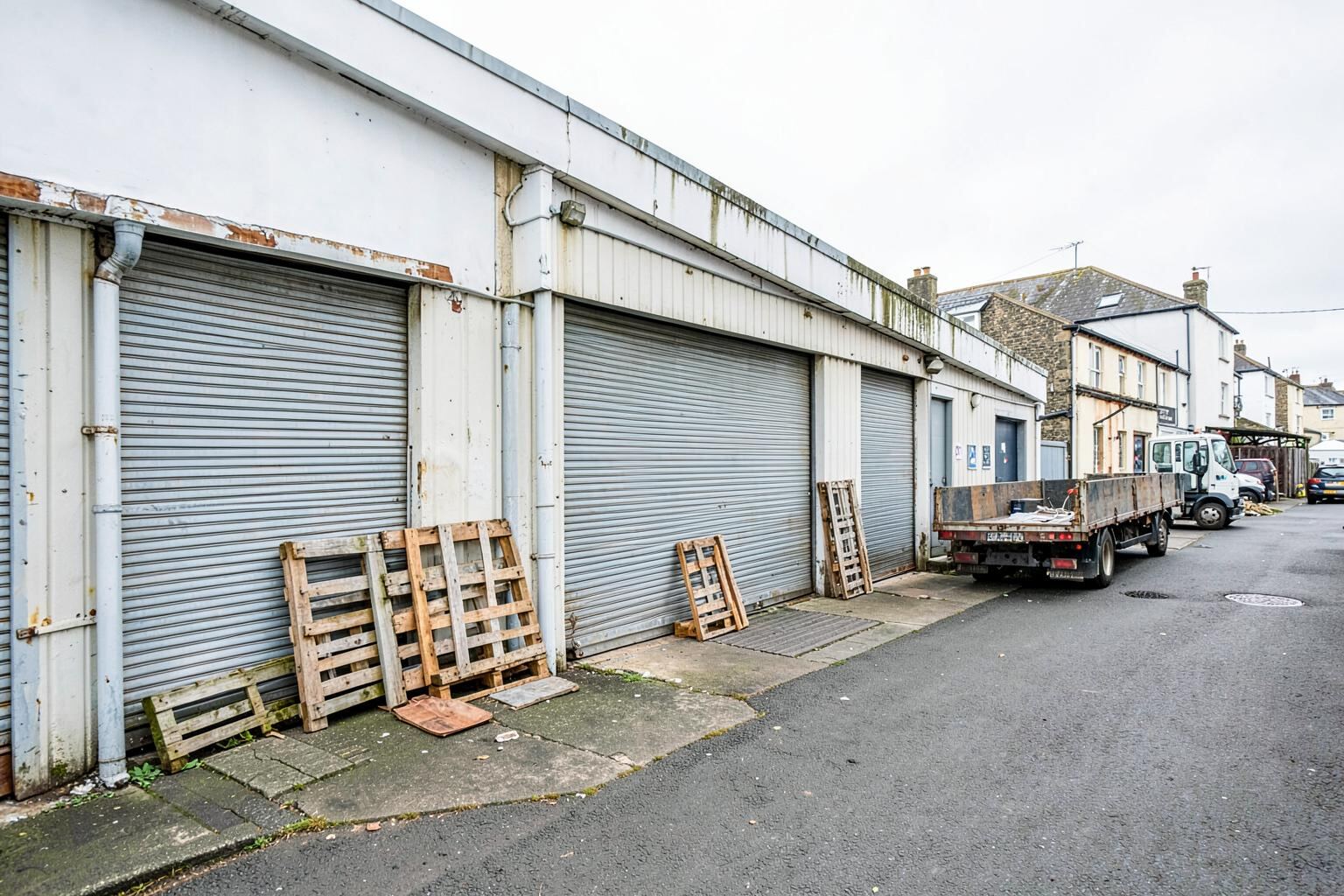A coastal industrial terrace with pallets stacked outside