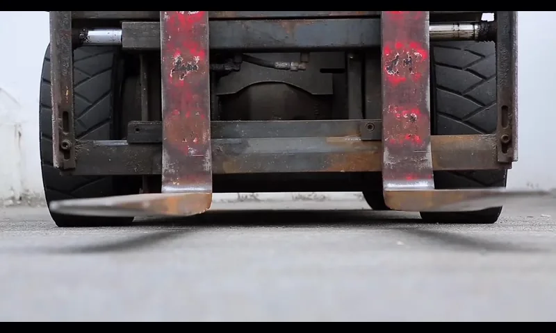 Forklift lifting a stack of timber pallets in the Palletmove yard